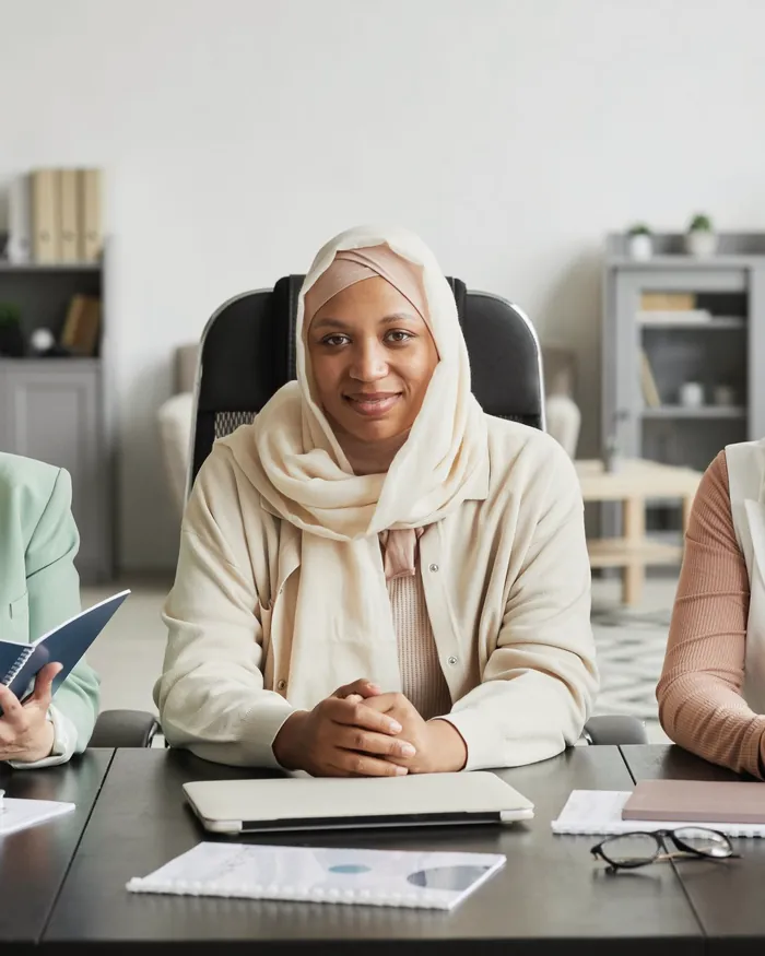 Women in hijab sitting together in a classroom