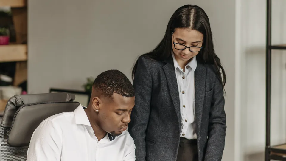 Two colleagues reviewing a contract at a desk